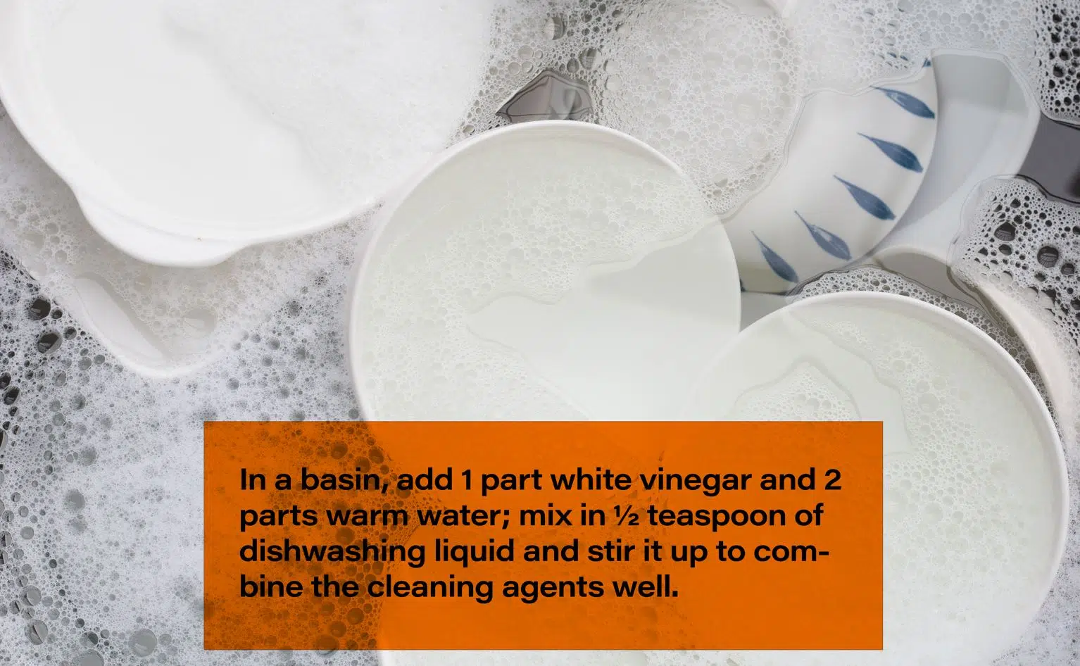 a number of food bowls submerged in soapy water