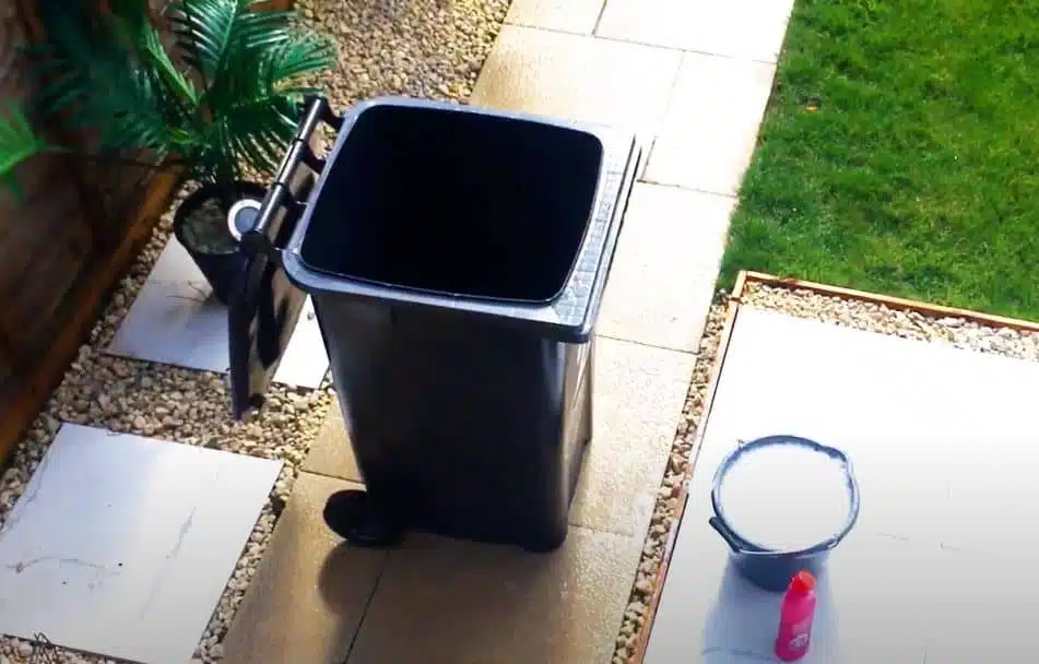after photo of a black wheelie bin that's been thoroughly cleaned with water and soap