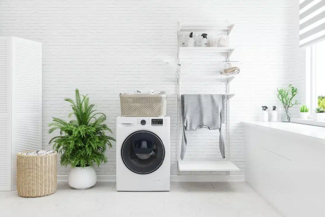 clean white inspired modern laundry with front loader washing machine in the foreground