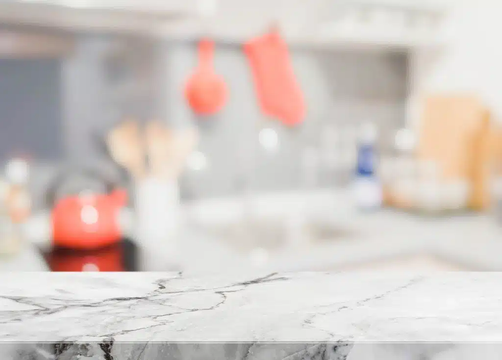 Grey marble table top and blurred kitchen interior background