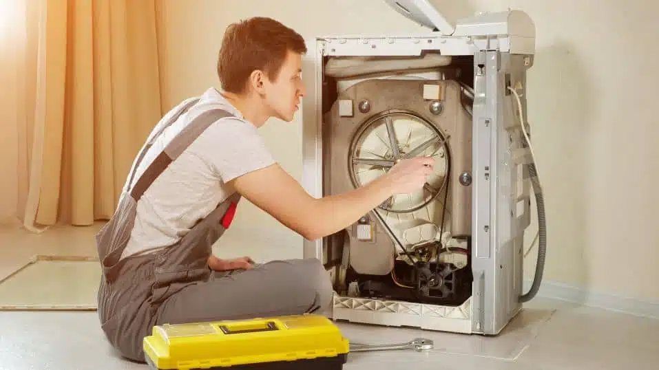 Man fixing a top load washing machine