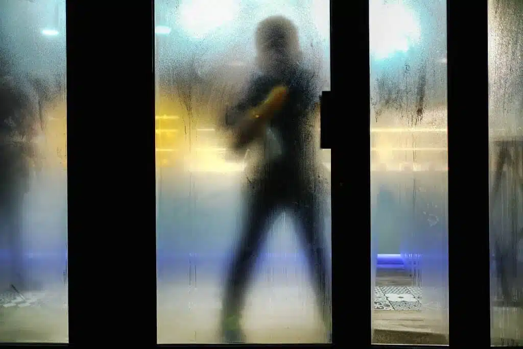 Man washing large window from the outside