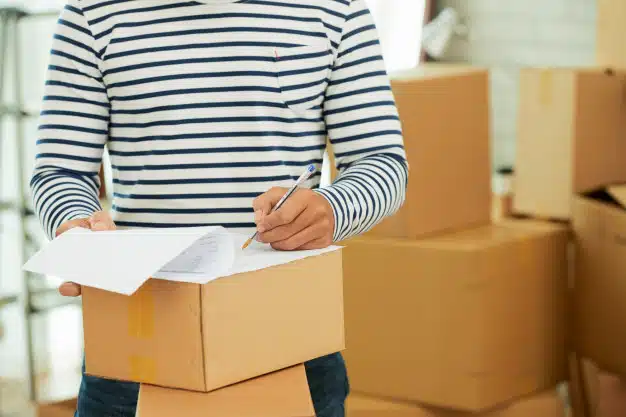 mid-section-man-striped-long-sleeve-shirt-filling-out-form-box