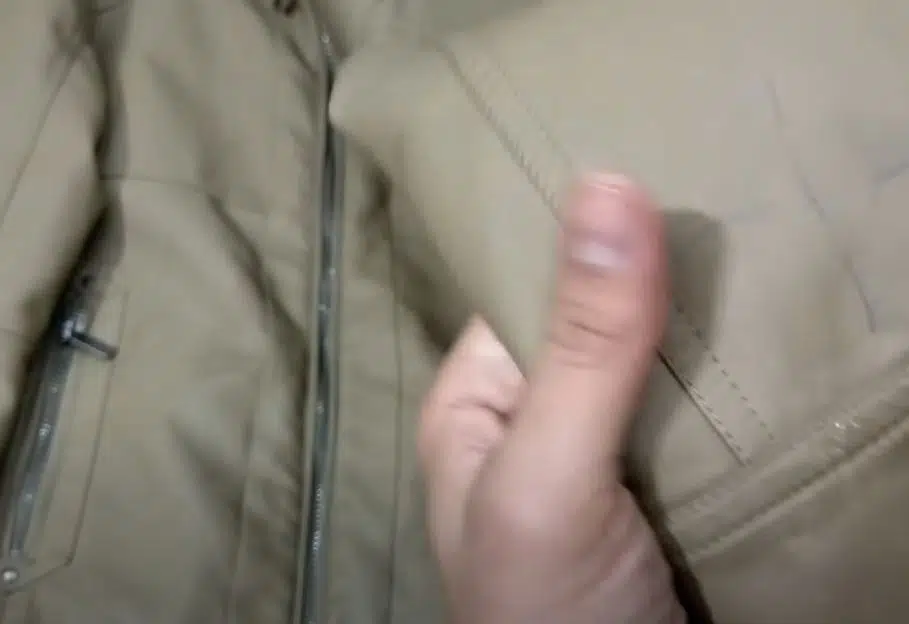 person removing ink stain from khaki coloured leather jacket