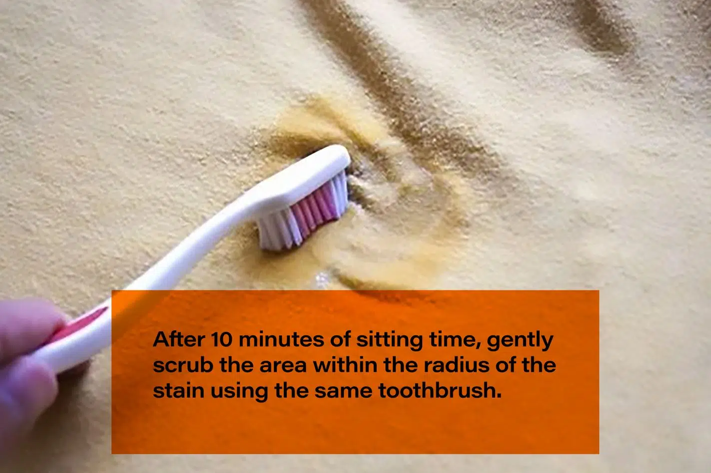 person using toothbrush to remove turmeric from clothing