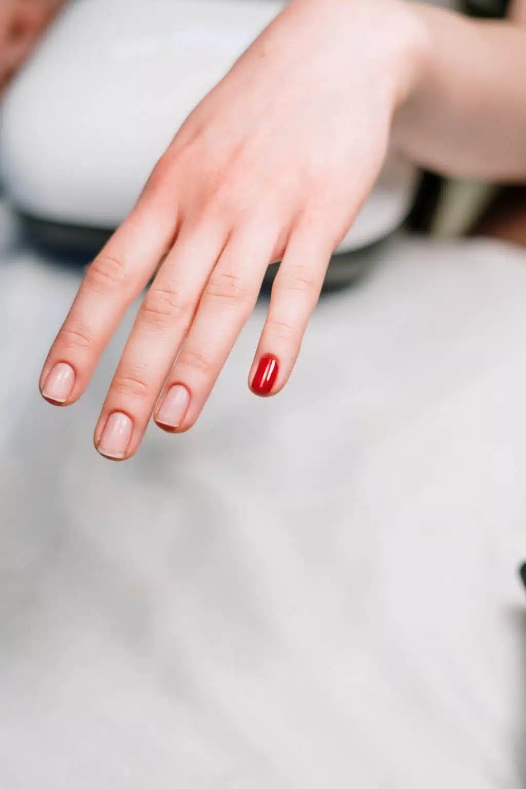 Person with red manicured nails