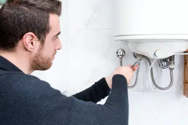 Plumber fixing electric water heater
