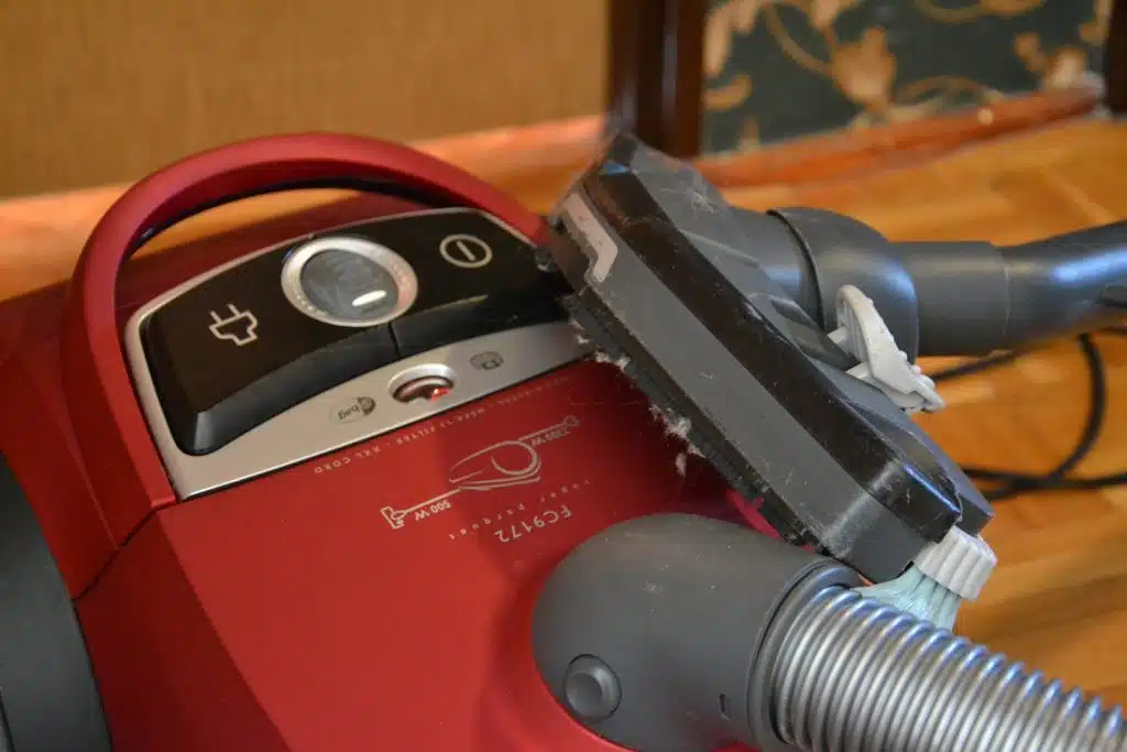 red vacuum cleaner on a hardwood floor