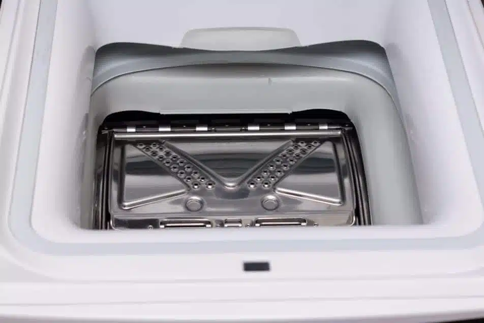 The inside of an empty top load washing machine