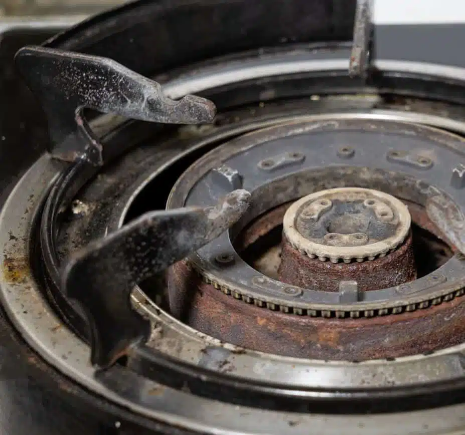 top view of a very old rusted and dirty stove burner