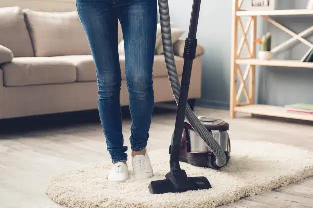 woman-jeans-using-vacuum-cleaner